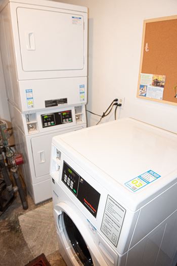 A white washing machine with a blue sticker on the top right corner.